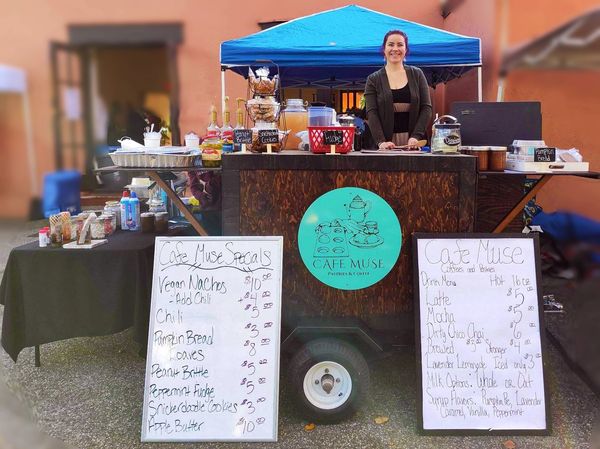 Owner/Operator standing behind hand built coffee cart at the very first event. 