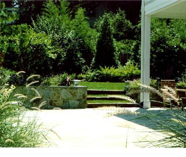 Modern patio overlooking a lush lawn.