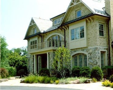 Grand stone estate with professional landscaping.