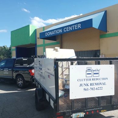 Junk removal truck and trailer parked out front of a donation center to drop off donatable items