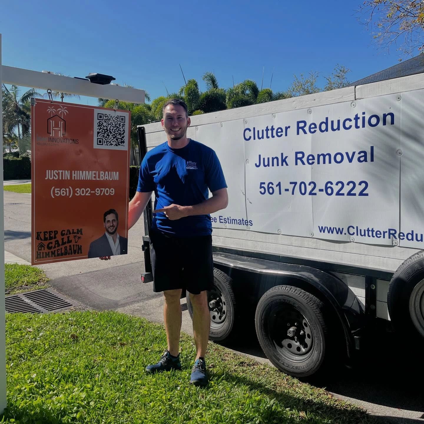 Man in blue shirt pointing to a sign with contact details for Justin Himmelbaum's junk removal service.