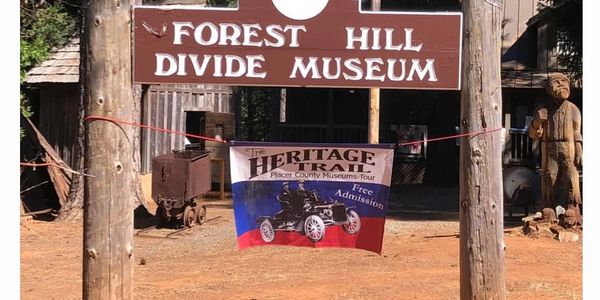 Entrance sign to Forest Hill Divide Museum with a Heritage Trail banner.