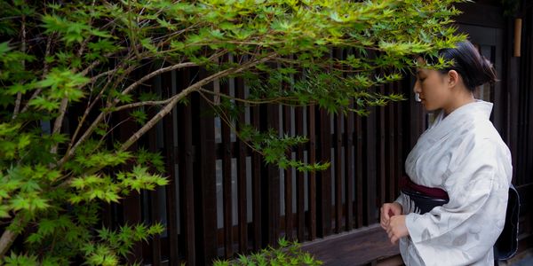 Kyo machiya townhouse with wooden lattice facade and tiled roof in Nishijin Kyoto, Kimono district