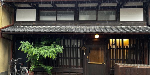 A traditional wooden house in the rain.