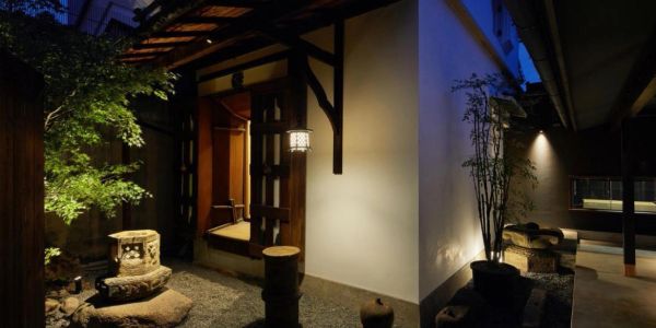 Cozy Japanese-style entrance illuminated at night.