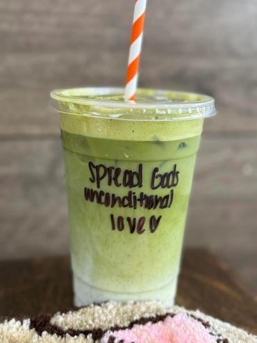 Iced matcha latte with a positive message on the cup.