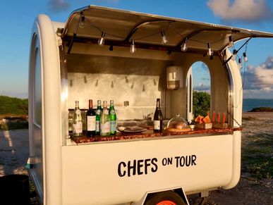 Mobile food cart labeled 'CHEFS ON TOUR' with drinks and snacks.