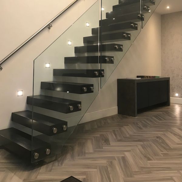 Stained black cantilever floating staircase