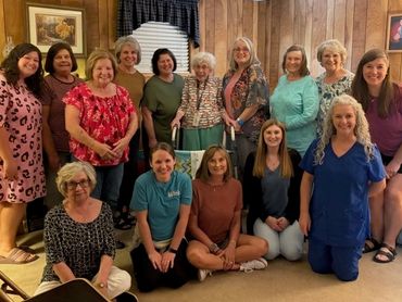 Group of women posing together in a cozy room.