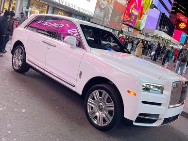 White Rolls Royce stages waiting for high end clients in Midtown NYC
