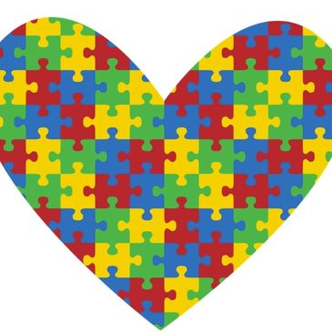 Heart shape made of colorful puzzle pieces.