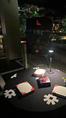 Mystical tarot reading setup with cards and candles on a dark table.