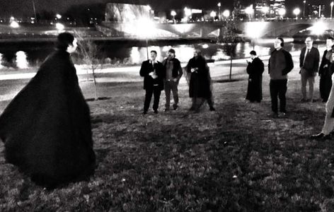 People taking an open air, socially distanced outdoor ghost tour. 