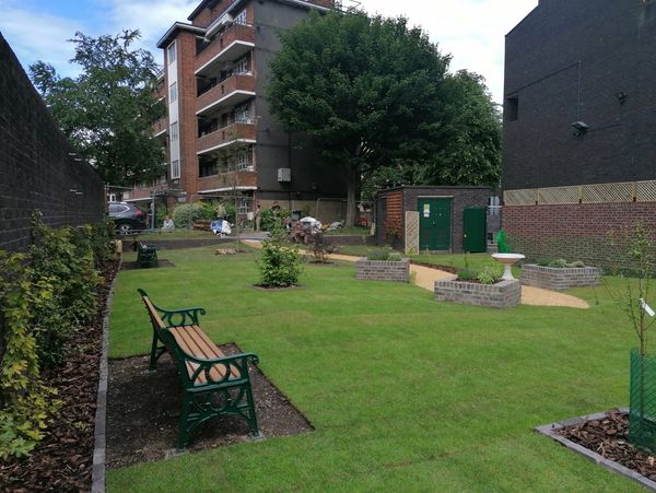 Small park with fresh grass, recently landscaped