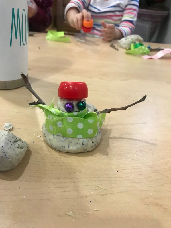 3 year old created a snowman with playdough and loose parts. 