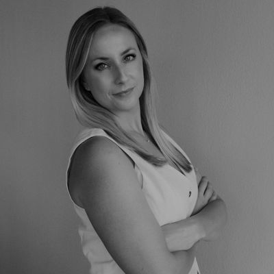 Confident woman with arms crossed, looking at camera.