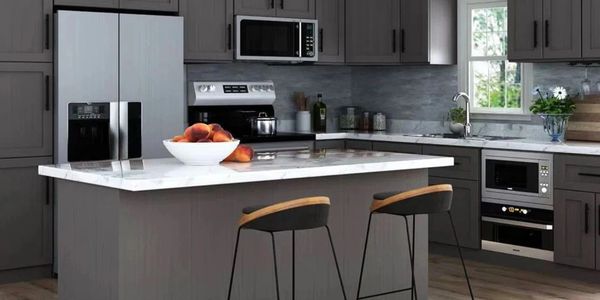 Modern kitchen with gray cabinets and marble island.