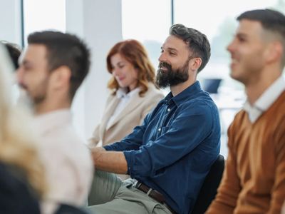 People attentively listening during a seminar or meeting.