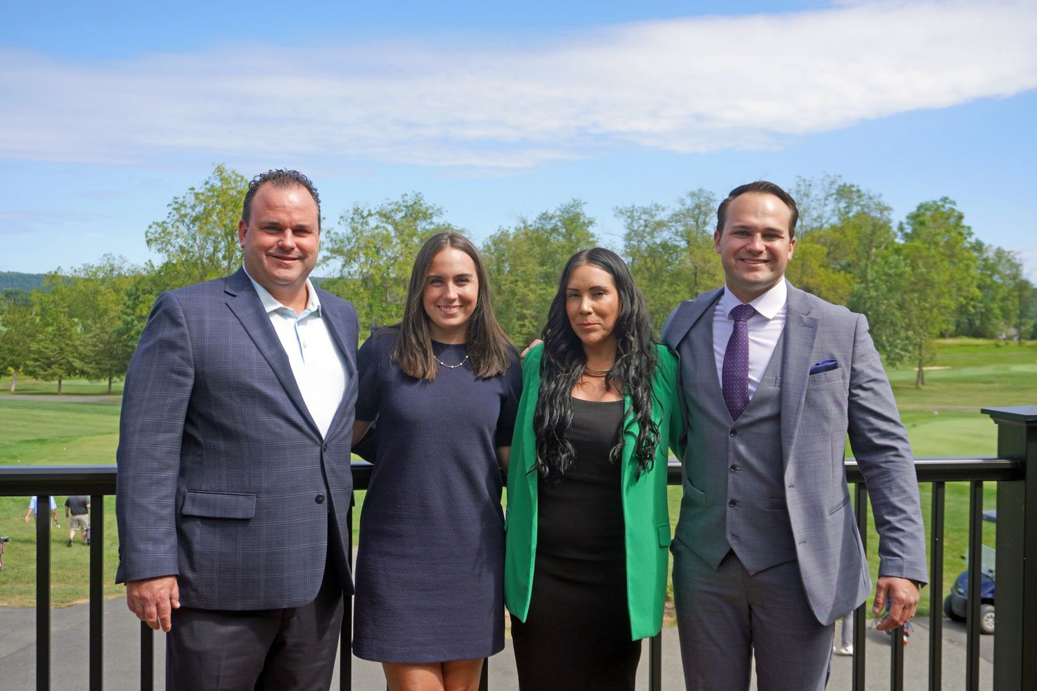 Close-up of hands typing on a laptop keyboard with a cup nearby.