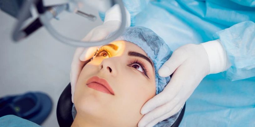 Patient undergoing eye examination or surgery under bright light.