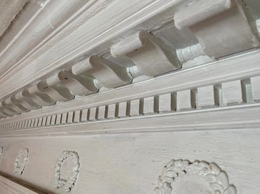 Some of the extensively ornate woodworking on the ceiling of the parlor room.