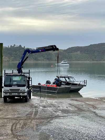 InDepth Diving Crane lifting equipment onto Barge and boat for dive operation to commence