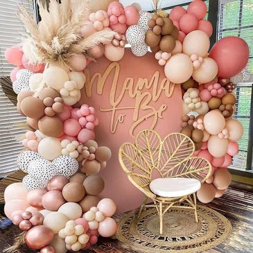 Boho Mame to Be baby shower decoration with chair and back drop.