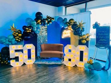 Blue and gold themed 50th & 80th birthday decor at Suite Events in Broken Arrow.