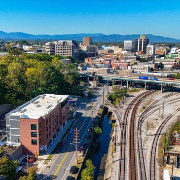 Aerial of downtown Roanoke and apartment community downtown with train yard