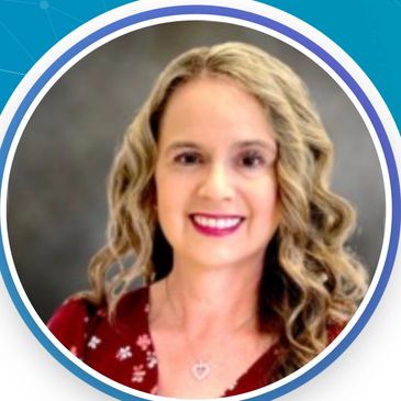 Smiling woman with curly blonde hair and a floral red top.