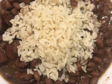 White rice on top of cooked beans.