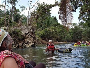 My Aunt Sharon on a Family Tour, Cave Tubing, Belize. Amazing tour guide helping with a photo.