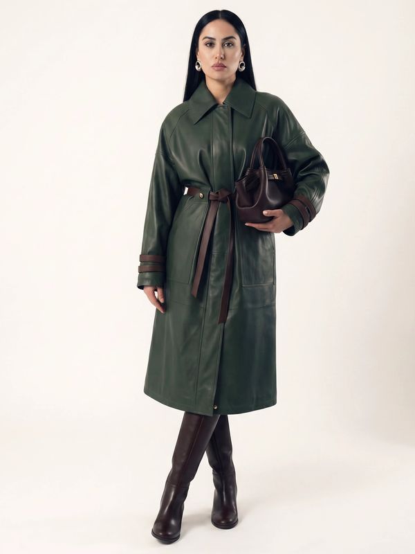 Woman in a green leather coat with brown accents.