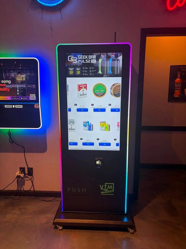 A neon-lit vending machine displaying tobacco products.