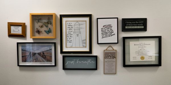 Therapy office wall art and professional counseling diplomas displayed in Jennesa Yanez’s healing sp