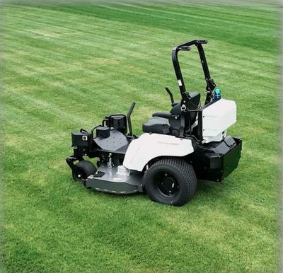 A white riding lawn mower on freshly cut grass.
