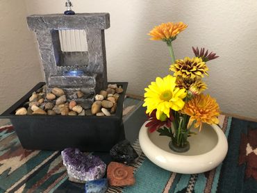 Office water fountain with ikebana flower arrangement