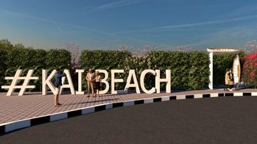 People posing by large #KATIBEACH letters near greenery on a sunny day by Bon Marche Interior Design Abu Dhabi