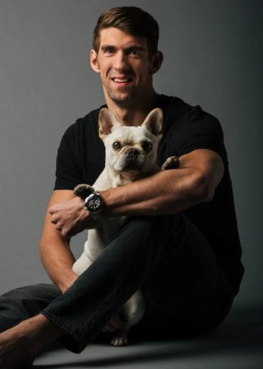 Man holding a French bulldog.