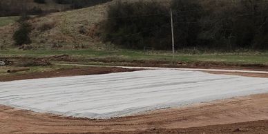 Post frame pole barn structure build site prepped gravel crushed limestone pad