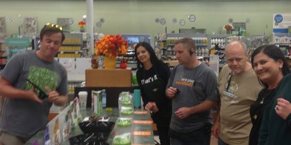 Group of five people shopping in a store.