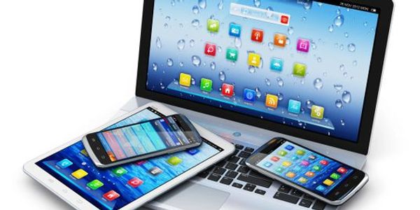 Laptop with tablet and smartphones displaying app icons.