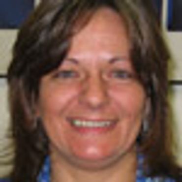 Smiling woman with shoulder-length brown hair.