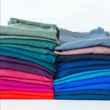 two piles of a variety of  solid color lularoe leggings
