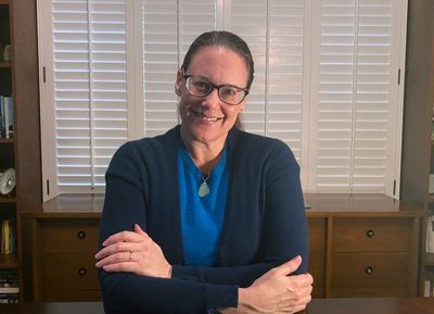 Shannon Littrell, editor, sitting at a desk