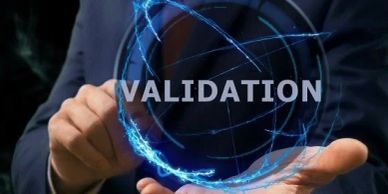 A person presenting the word 'VALIDATION' with digital blue light effects.