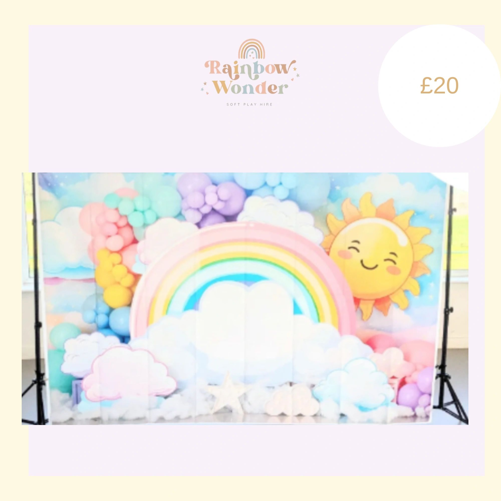 Colorful rainbow and sun-themed soft play setup with balloons and clouds.