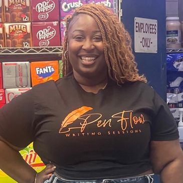 Smiling woman in a Pen Flow Writing Sessions t-shirt inside a store.