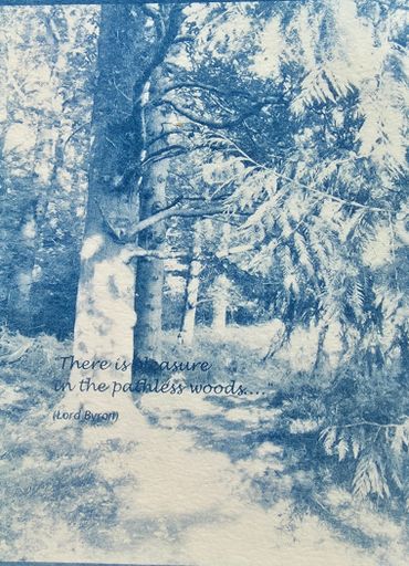 A serene woodland path with a quote from Lord Byron.