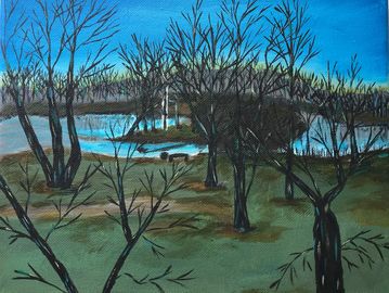 A serene landscape with bare trees by a river under a blue sky.